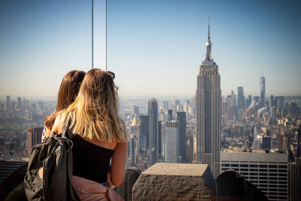 Young girls watching New York skyline on a bright sunny day