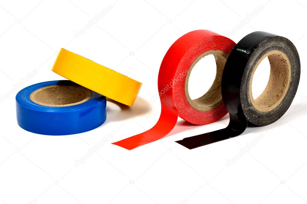 Several coils of colored tape (insulating tape) on white background