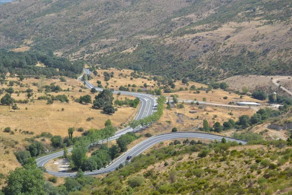 Curved road in San Lorenzo El Escorial, Madrid, Spain