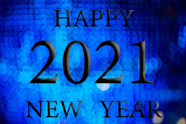 Happy New Year 2021. Background with Bokeh effect with Christmas lights. Black letters and numbers.