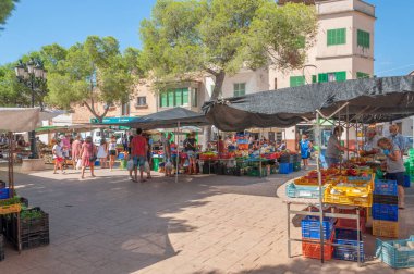 Campos, Balear Adaları / İspanya; Ağustos 2020: Campos 'taki geleneksel sokak pazarında meyve ve sebze tezgahı. Covid-19 'un yeni sosyal önlemleri için eldiven ve maskeli satıcı ve alıcılar