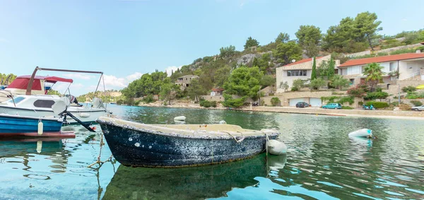 Old boat docked in the port of Bobovisca village. Overgrown with seashells and seaweeds as an ancient relic of the past