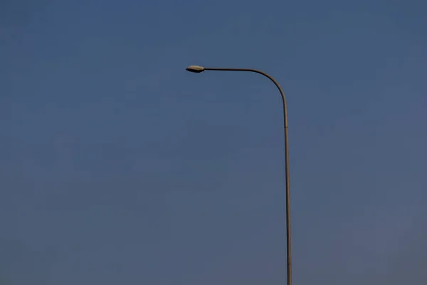 Die Vom Hintergrund Des Himmels Isolierte Straßenbeleuchtung Ist Blau Stockbild