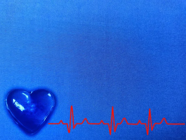 glowing blue heart with red cardiogram graph on blue texture.