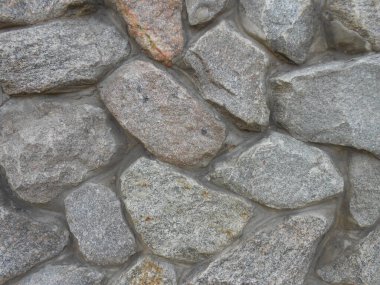 background of masonry of large gray stones and concrete mortar clipart
