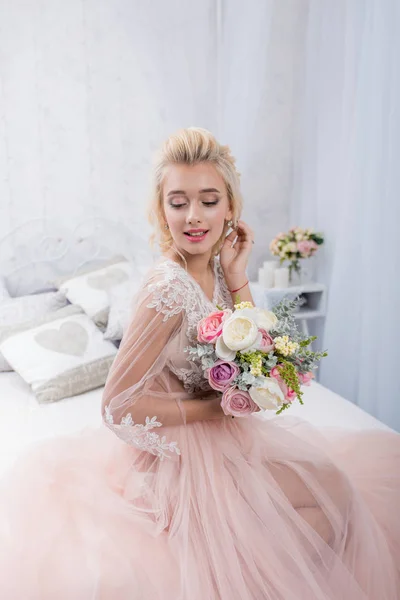 Beauty fashion bride in winter decor with bouquet of flowers in her hands. Beautiful Bride portrait wedding makeup and hairstyle. Fashion bride model in luxury wedding dress. Beauty girl face, gorgeous beauty bride.