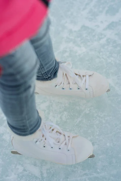 Menina adolescente patinação com patins brancos na área de gelo — Fotografia de Stock