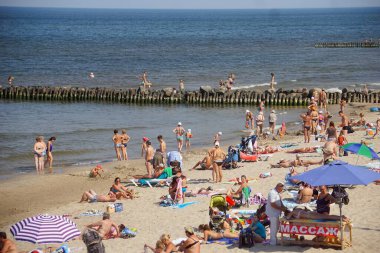 Sahilde yıkanan ve güneşlenen insanlar..