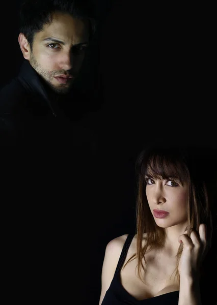 Book cover design . dramatic fashion man and woman on black background