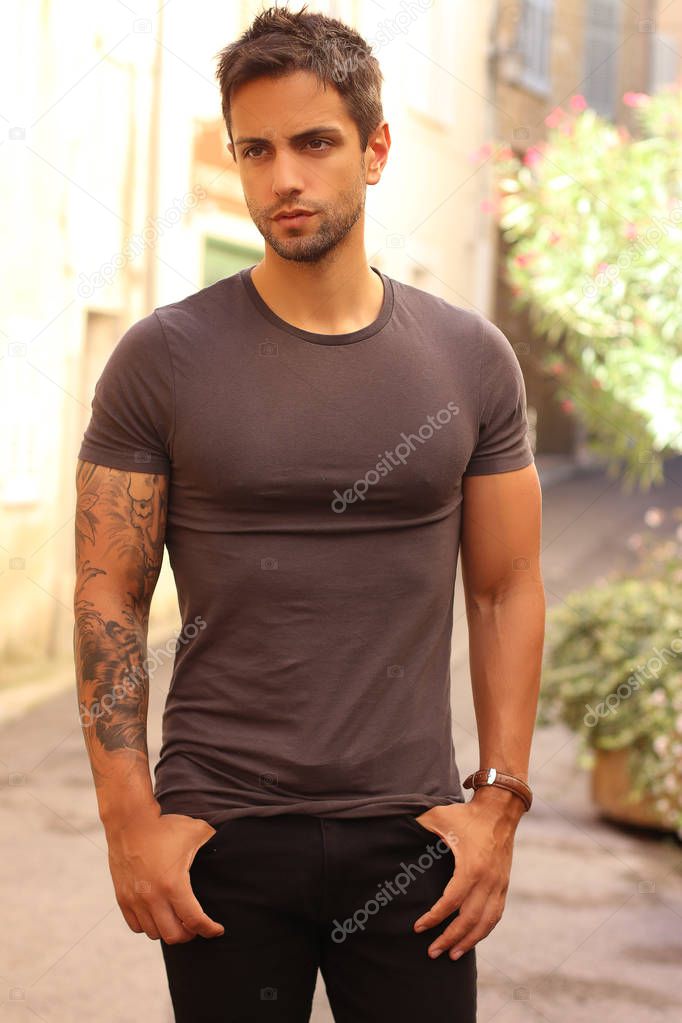  handsome male model wearing gray t-shirt in casual urban style