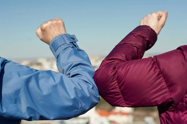 Elbow bump. Greeting with no hand touching. Elbow greeting in quarantine concept.