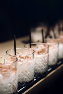 line of white russian cocktails at bar counter. vertical. copy space