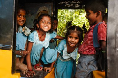 23 february 2018 Madurai, India, group of indian schoolgirls smiling to camera in tuk tuk rickshaw