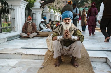 old indian sikh praying nearby golden temple. 26 february 2018 Amritsar, India.