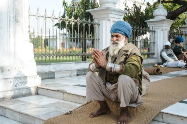 old indian sikh praying nearby golden temple. 26 february 2018 Amritsar, India.