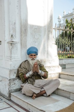 old indian sikh praying nearby golden temple. 26 february 2018 Amritsar, India.
