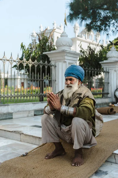 old indian sikh praying nearby golden temple. 26 february 2018 Amritsar, India.