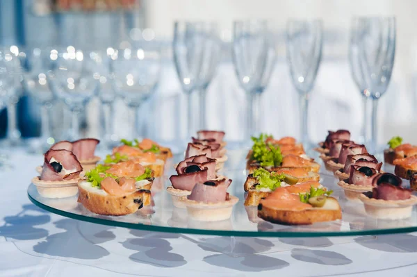 canape set with salmon fish and meat at luxury reception. catering food luxury service