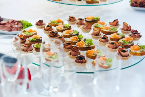 canape set with salmon fish and meat at luxury reception. catering food luxury service