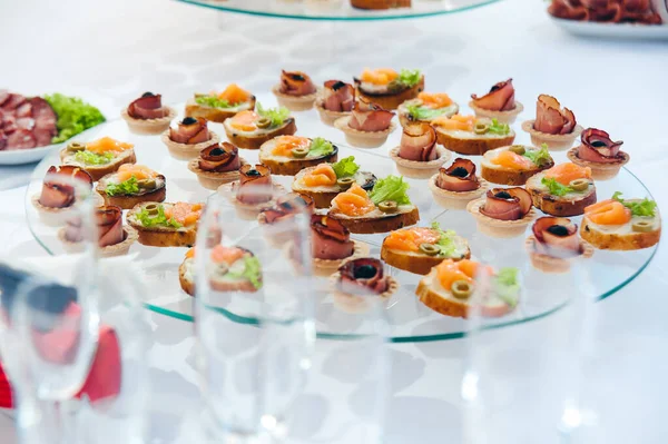 canape set with salmon fish and meat at luxury reception. catering food luxury service