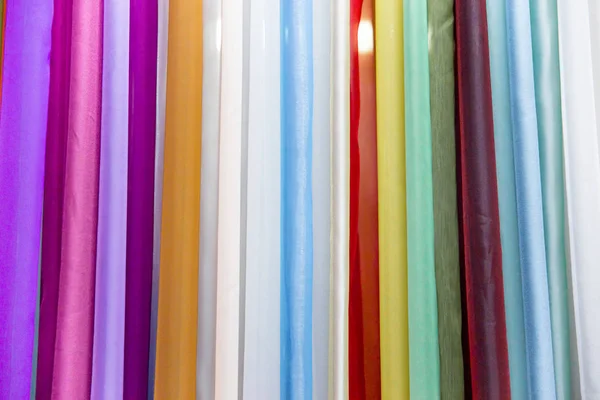 Rolls of colorful fabric and textiles in a shop or store