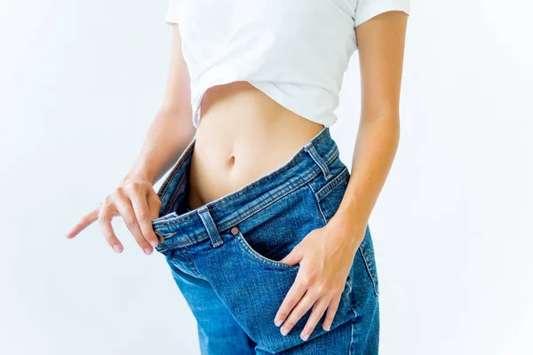 Fit woman measuring waist with measuring tape — Stock Photo, Image