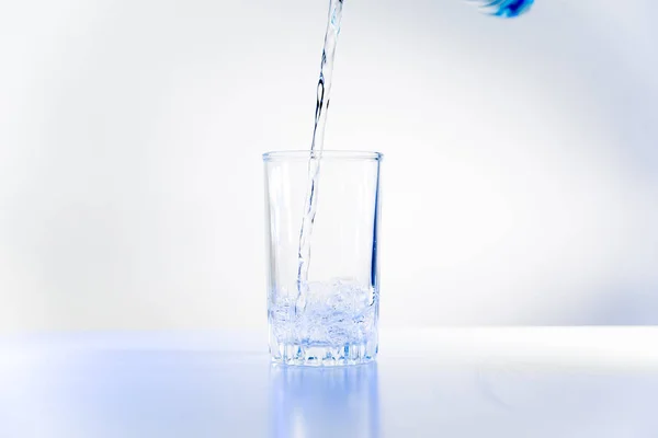 Bicchiere di acqua pura su un tavolo da cucina bianco — Foto Stock