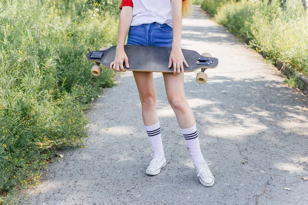 Schöne Skaterin auf ihrem Longboard in der Stadt — Stockfoto