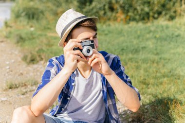 Genç adam gezgin doğada fotoğraf çekme