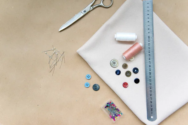 Set of sewing tools - scissors, needles, buttons, thread on a table — Stock Photo, Image