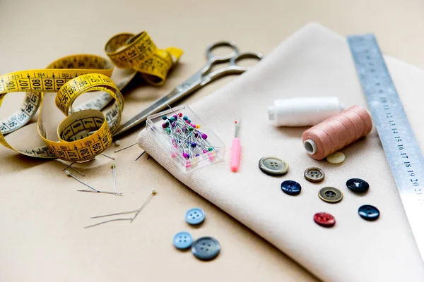 Set of sewing tools - scissors, needles, buttons, thread on a table — Stock Photo, Image