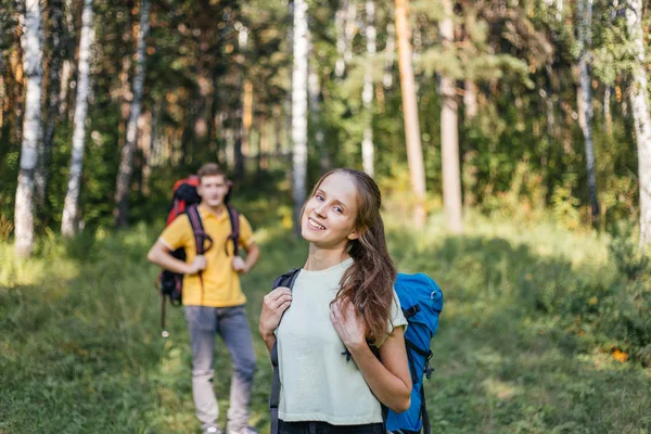 Para turystów z plecakami, wędrówki w lesie — Zdjęcie stockowe
