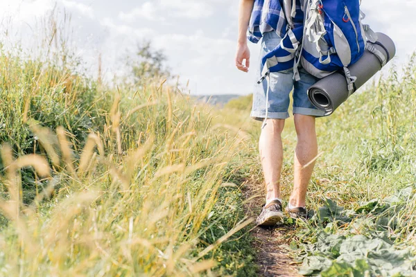 Jonge reiziger man wandelen met een rugzak in de natuur — Stockfoto