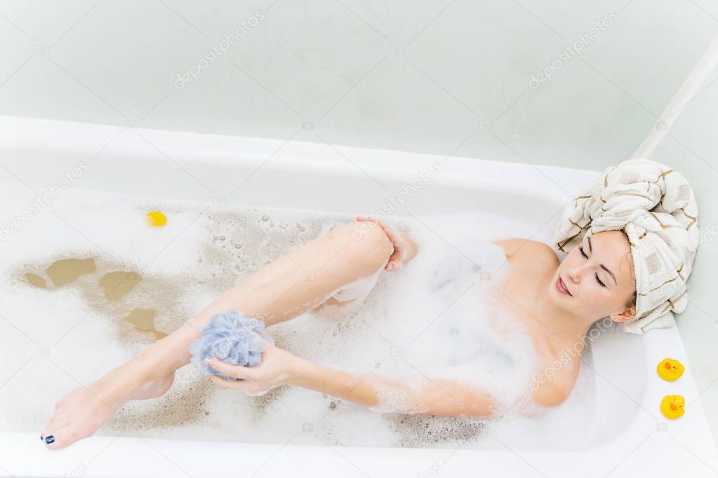 young woman is relaxing in a bathtube