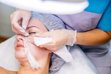 Genç güzel kadının yüz maskesi yordamı