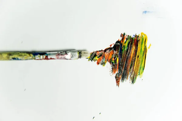 Several paintbrushes with paint on a table — Stock Photo, Image