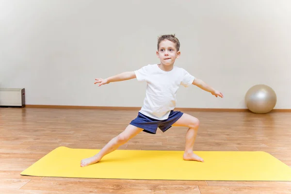Ein kleiner Junge praktiziert Yoga zu Hause — Stockfoto