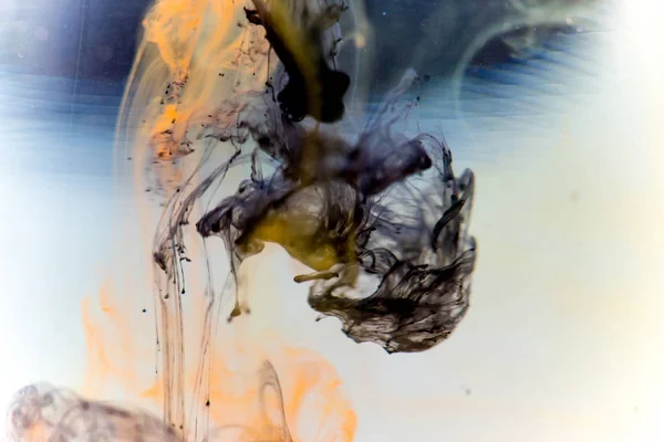 a drop of paint pouring in water