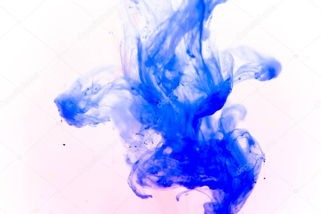 a drop of paint pouring in water