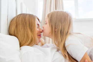 mutlu gülümseyen hamile anne kızıyla birlikte evde sarılma