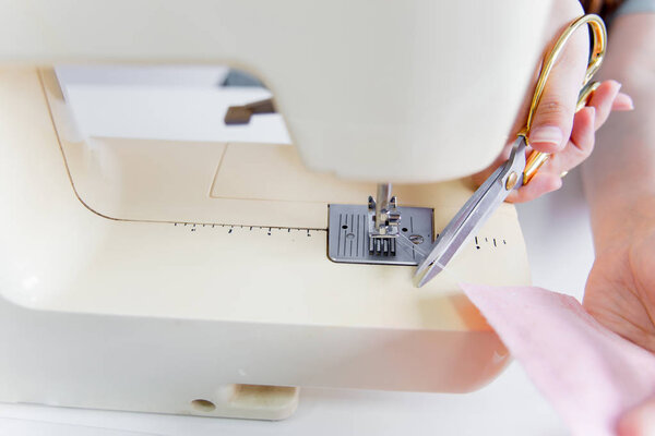 Female hands are using a sewing machine - tailoring process
