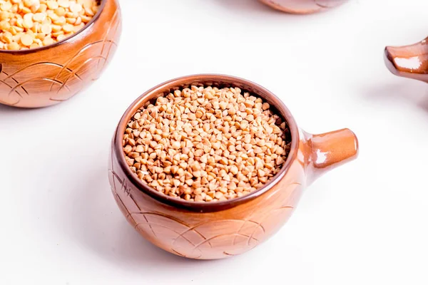 Different types of groats in pots on a white background — Stock Photo, Image