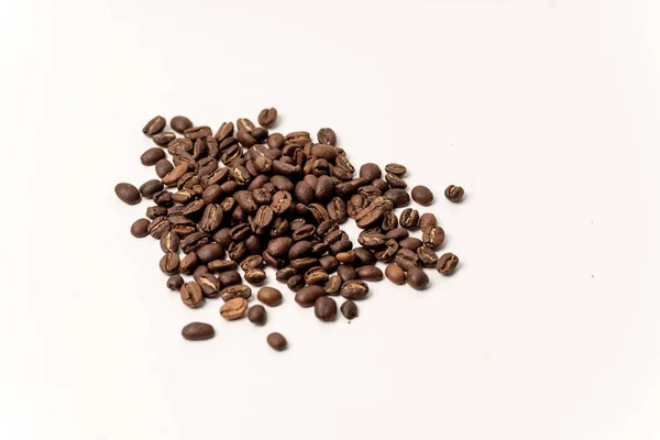 Beyaz zemin üzerinde kahverengi kahve çekirdekleri — Stok fotoğraf