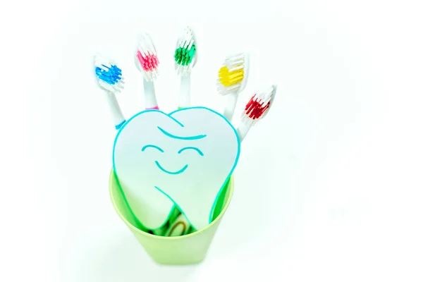 Toothbrushes and a toothpaste on a colorful background — Stock Photo, Image