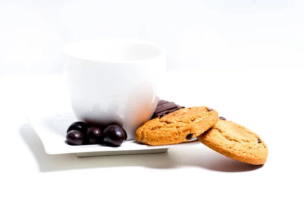 Chocolate bar, shavings and cookies on a table — Stock Photo, Image
