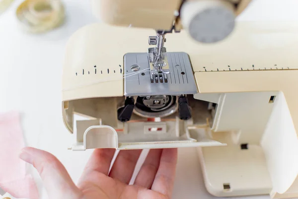 Manos femeninas están utilizando una máquina de coser — Foto de Stock