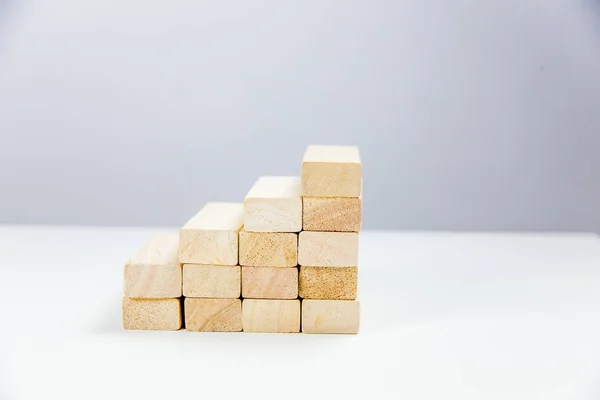 Wooden bricks laid out in the form of a ladder up