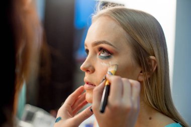 Genç kız çalışma profesyonel makyaj sanatçısı