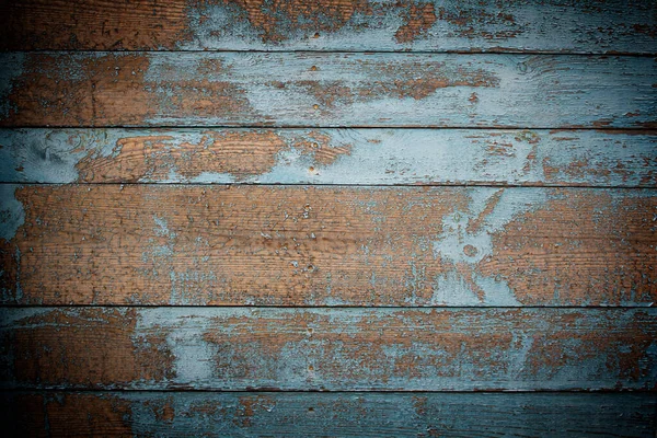 Natural wooden background of six brown boards covered with in places of blue paint — Stock Photo, Image