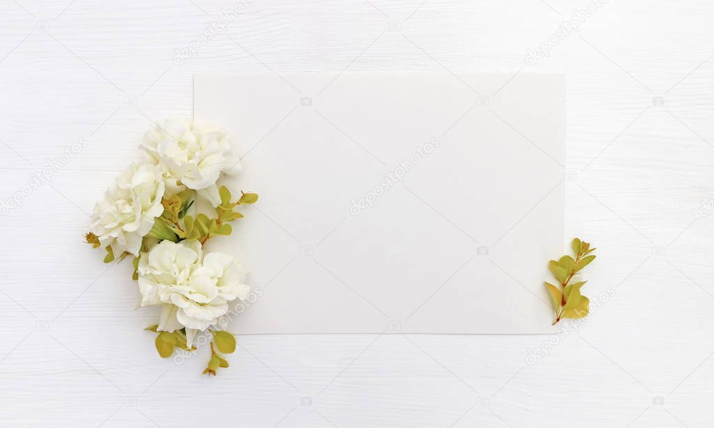 Mockup with a blank A5 paper sheet, white flowers